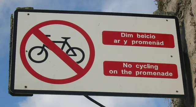 Bilingual cycling traffic sign in Welsh and English in Caernarfon, Wales Photo taken by Man vyi with Canon PowerShot A40 on 1/10/2004. What Cardiff Council's Welsh Language Standards require of bilingual English and Welsh content