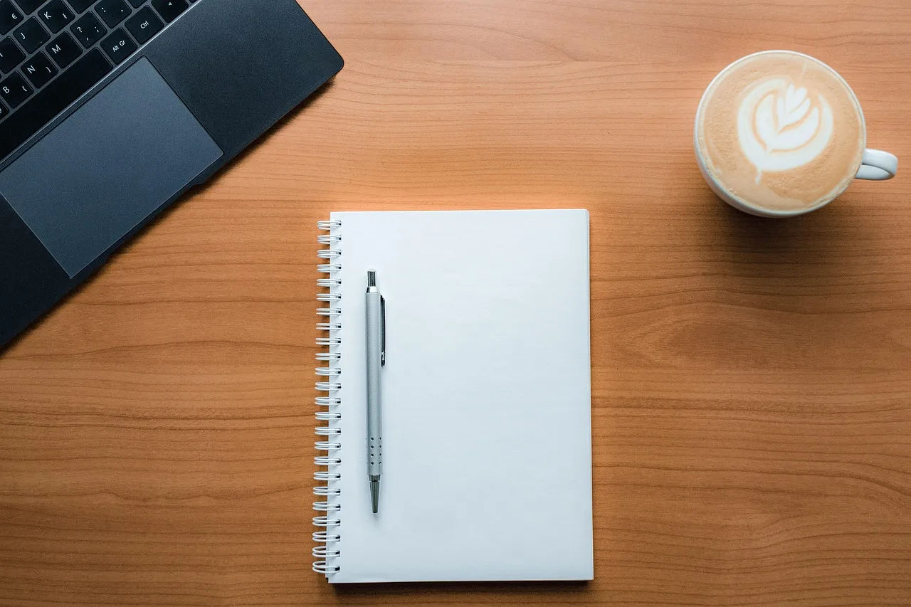 coffee, coffee table, latte, latte art, pen and paper, notebook, table, laptop, space gray laptop, notebook on a table, coffee and paper, writing
