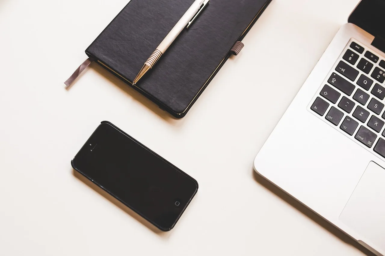 apple, computer, desk, iphone, laptop, macbook, mobile phone, notebook, pen, smartphone