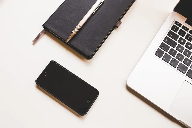 apple, computer, desk, iphone, laptop, macbook, mobile phone, notebook, pen, smartphone. England copywriting costs: price examples and quote factors